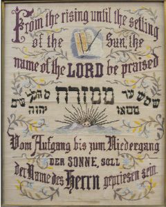 Multicolored needlepoint in English, Hebrew and German. "From the rising until the settling of the sun, the name of the Lord be praised." In center the rising sun with Moses bearing the tablets above, floriated embellishments throughout