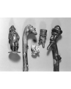 Zinc pepper pot, in form of Jewish man with tri-corn hat.  Alsace, 19th century. * Two wooden walking sticks, England, 19th century. * Wooden pipe head, probably Germany, 19th century. *Painted porcelain head, probably Russia, 19th century.  Various sizes