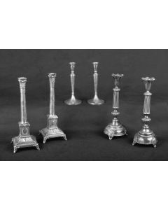 Round base, embossed with grapevine and floral patterns, on three openwork feet; one knob beneath reeded shaft.  Tulip form candlecups; no bobeches.  Marked on base.  H:  310mm. Some wear