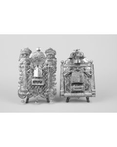 Two pilars flank engraved central section with plaque box (one brass plaque); above, miniature Torah Ark with Decalogue engraved on doors flanked by lions rampant. Above, crown with bells and bird finial. Marked at center. H: 310 mm.