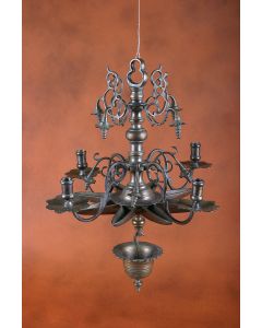 Trefoil loop, bulbous shaft with cast swirl and bead ornaments near top; near base, candleholders on S-form arms atop 5 pointed star-form oil container; drip bowl hangs from base of shaft. Length: 25 inches.