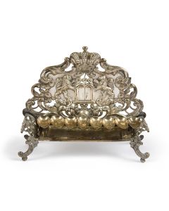 Removable oil-tray set on couch-form, with repousse backplate. Marked. Height: 8.5 inches.