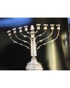 Menorah-form, central shaft with flame atop, applied foliage to eight branches, the whole set on raised dome. With attached servant light.
Height: 7 3/4 inches (20 cm), length: 9 3/4 inches (25.1 cm).