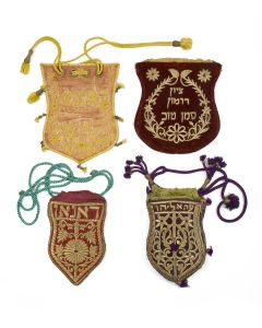 Group of four. Lavishly embroidered with scrollwork. Jewel toned velvet bags and cords. Hebrew inscriptions and English character monogram. Range: 9-11 x 6-9 inches.
