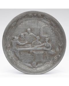 Cast in high relief, depicting the baking of matzahs, with two related (worn) Hebrew verses below. Diam: 8.5 inches.