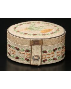 Oval-form embroidered with traditional Hebrew verse relating to the Sukoth Festival, Ethrog-fruit and Lulav depicted on hinged lid. 3.5 x 7 x 5 inches.