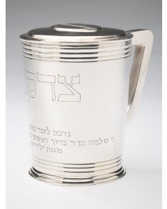 Tankard-shaped in the Postmodern style. Engraved in Hebrew. Marked. Hinged door on reverse, with key. Height: 5 inches.