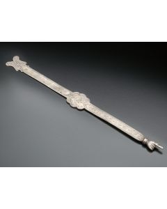 Flat body engraved with Hebrew inscription, with rosette at midpoint terminating in articulated hand. Length: 10.5 inches.