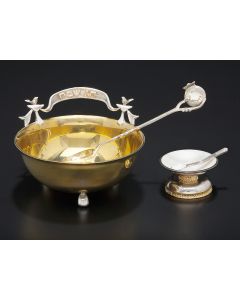 Petite silver, parcel gilt silver and enameled salt cellar and accompanying spoon. Numbered 46/500. Marked. Height: 1 inch; Diameter: 1.75 inches. Spoon: 1.75 inches.