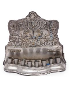 Backplate featuring lions flanking Menorah; fronted by bench supporting eight oil receptacles. 5.5 x 6.5 inches.