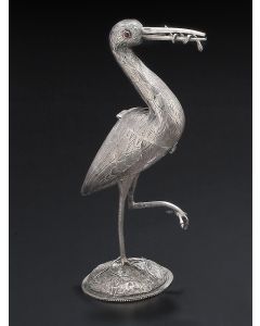 Of stork-form, realistically wrought, chased and engraved, in vigilant pose on one leg with worm in mouth, set on a circular base, with hinged torso. Marked. Height: 10.25 inches.