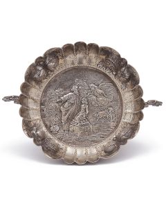 Chased with depiction of the Sacrifice of Isaac and engraved in Hebrew: “Do not raise your hand on the boy” (Genesis 22:12). With beaded and scalloped rim chased with fruit-forms. Two scroll handles applied. Marked. Height” 1.75; Diameter: 6.75 inches.