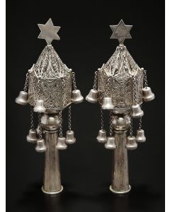 Of hexagonal-form and steeple peaks of fligree workmanship, with Star-of-David finials (one later); two tiers of pendant bells on chains (few lacking) and tubular staves. Height: 9.25 inches.