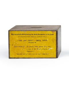 Rectangular box bearing label: “The Society for Distributing the Holy Scriptures to the Jews, 237 Shaftesbury Avenue, London… Our Object: To provide every Jewish home with a copy of the Hebrew-English New Testament.” With coin slot. 3.5 x 6 x 2.5 inches.