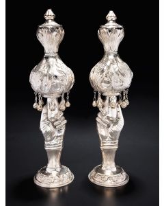 Baluster-like shape composed of two-tiered bulbous upper portion with dense foliate motif, hung with eight enclosed bells. Lower portion in naturalistic hand-form staves set on circular base. Marked. Height: 15.5 inches.