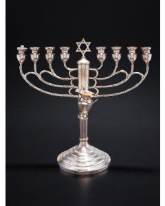 Of classic form, chased branches in branch-like motif; central shaft with Star-of-David finial, the whole set on round, graduated dome. With removable oil ewer; lacking servant light. Marked. 10.25 x 10.5 inches.