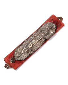 Repousse featuring central column bearing Hebrew name of God surrounded by stylized flowers, the whole set on red. Length: 5.5 inches.