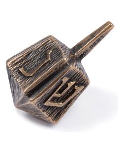 Designed by Ludwig (Yehudah) Wolpert. Each fluted side features one of the four Hebrew letters appropriate to the traditional game. Marked along handle: “Wolpert.” Height: 1.5 inches.