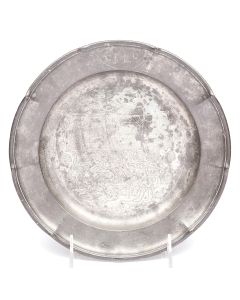 Round plate with raised rim surrounds central image of a man and animals, featuring the (later) engraved Hebrew word “Lefichach.” Marked on rear “Block Zin[n]” and “Georg Klingl” along with the archangel Michael. Diameter: 8.25 inches.