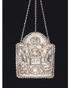 Arch-form breastplate, repousse with foliate, shell and scroll devices. Central frame with Hebrew word “Sabbath” flanked by rampant lions. All suspended from linked chain (later). Unmarked. 6.75 x 5.5 inches.
