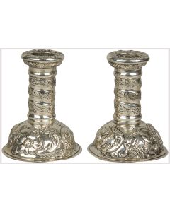 Art-Nouveau inspired forms decorate the candlesticks. Lavish foliage with high-relief fruits and flowers adorn the circular base. Candle sockets are embellished with an assortment of elaborate flowers. Marked. Height: 4.4 inches (11.2 cm).