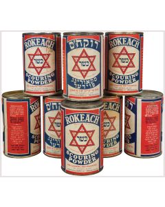 Group of eight unopened cans “Kosher for Passover.” Labeled in Yiddish and English in red, white and blue.