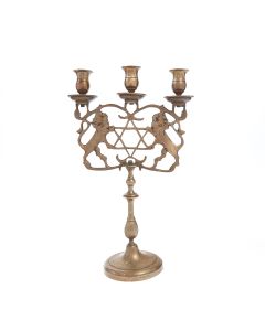Three sconces raised above a pair of rampant lions supporting a large central Star of David, the slender, part-fluted column descending to a circular base. H: 37.5 cm (14 inches).