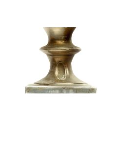 Of tower form, the square container fitted with hinged door, above which is a clock-face with moveable clock-hand.