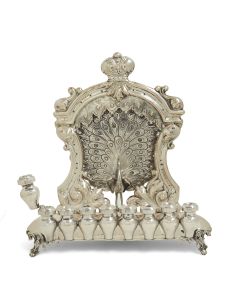 Bench form lamp with detachable row of eight oil urns and removable covers with wick apertures, the whole set on four ornamental feet; back wall consisting of theatrical drapery crowned with central coronet. 