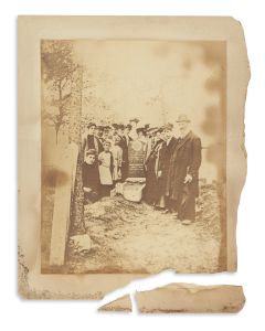 <<Photograph>> of a Jewish family gathered at the grave of Mary Benovitz.