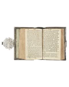<<German Silver Binding.>> Pierced and chased with foliate scrollwork and two dolphin heads flanking the hands of Cohen. Marked (twice) with maker's mark and Nuremberg city mark. <<Fitted with:>> Chumash [Pentateuch]. Amsterdam, 1767.