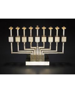 Agam’s “Dreidel” Chanukah Menorah. Gold/rhodium finish design of kinetically moving fonts, each in the shape of a dreidel. The whole set upon rectangular base. Signed and numbered on base “Agam 221/225.” In original, fitted carrying case. 9.5 x 14 inches.