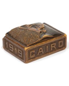Carved keepsake box with hinged lid bearing striking image of a lion. With raised carvings along perimeter: “1919, Cairo, Egypt.” 1.5 x 4 x 3 inches.