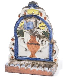 Glazed, arched backplate with vase and flowers painted over relief, servant light attached above. Row of oil fonts at base. Evidence of repairs. 8.5 x 6 inches.