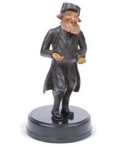 Painted, carved wooden figurine of a full-bearded Jew in swallow-tail coat and hat; mounted on circular wooden base. Repaired. 8.5 inches (including stand).