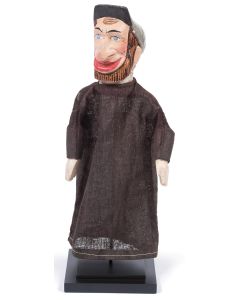 Painted wooden head of a bearded Jew with long tunic and peddler hat; with attached wooden arms. Mounted on dowel and square wooden base. Height: 12 inches.