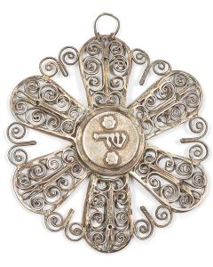Six-sided star accomplished in delicate filigree scrollwork surrounding central compartment with detachable lid bearing Hebrew Divine Name. With hanging element. Apparently unmarked. Diameter: 4.75 inches.