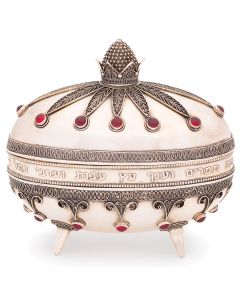 Ovoid-form container with detachable lid the whole bearing delicate filigree and red cabochon gemstones. With customary Hebrew acid-etched inscription. The whole set on four conical feet. Marked. 6 x 6.25 inches.