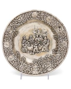 Wide, raised rim bearing medallions of the Twelve Tribes. The whole chased, engraved and repousse with central image of family seated at the Passover Seder. Diameter: 11.75 inches.
