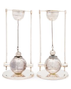 Striking modern design incorporating magnets and suspended candle holders. Marked. Height: 8.25 inches.