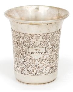 Densely engraved with scrolling foliate motif supporting small cartouche bearing Hebrew words: “Goblet for Passover.” Marked. Height: 3.5 inches.