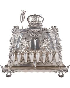 Removable row of eight oil/candle sockets; draped backplate featuring central Decalogue with rampant lions flanking and coronet above, the whole set on four shell supports. Removable servant-light. Marked. Height: 9.2 inches (23.4 cm).