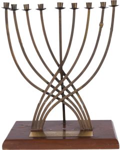 Brass, set on wooden stand. Dedicatory plaque to Rabbi Wolfe Kelman from The Jewish Theological Seminary of America. Wax residue. Height: 10.5 inches (10.7 cm).