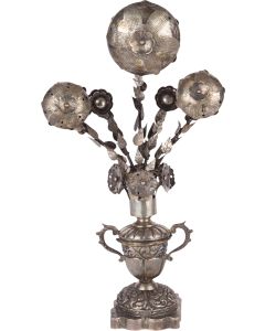 Large bouquet of pierced flower-bud forms with leafy stems arranged in chased urn atop scalloped, square base. Marked. Height: 11 inches (27.9 cm).