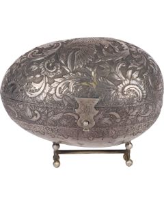 Textured fruit-form container with hinged lid bearing intricate scroll design featuring central double-headed eagle motif. With central clasp. The whole set on four ball feet. Length: 6 inches (15 cm). Hinge damaged.