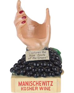 Plaster bar-display featuring female hand rising from a concord grape cluster. Placard reads: “Captures the True Taste of the Grape.” 11.5 x 6 inches (29.2 x 15.2 cm).