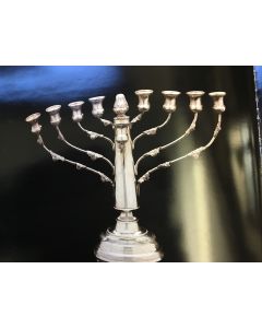 Menorah-form, central shaft with flame atop, applied foliage to eight branches, the whole set on raised dome. With attached servant light.
Height: 7 3/4 inches (20 cm), length: 9 3/4 inches (25.1 cm).