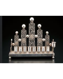 Of striking Art Nouveau style. Row of eight candleholders at front, with servant light alongside. Marked. 7 x 8 inches.