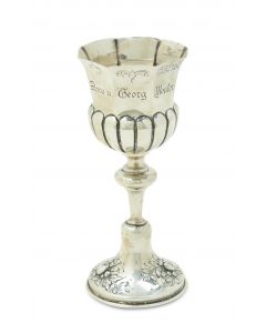 On round base with knobbed stem that attaches to octagonal wine section. Engraved with the names Dora and Georg Mosler and the Hebrew verse: “I Have Taken You for My Nation.” Height: 6.7 inches (17 cm).