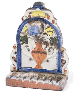 Glazed, arched backplate with vase and flowers painted over relief, servant light attached above. Row of oil fonts at base. Evidence of repairs. 8.5 x 6 inches.
